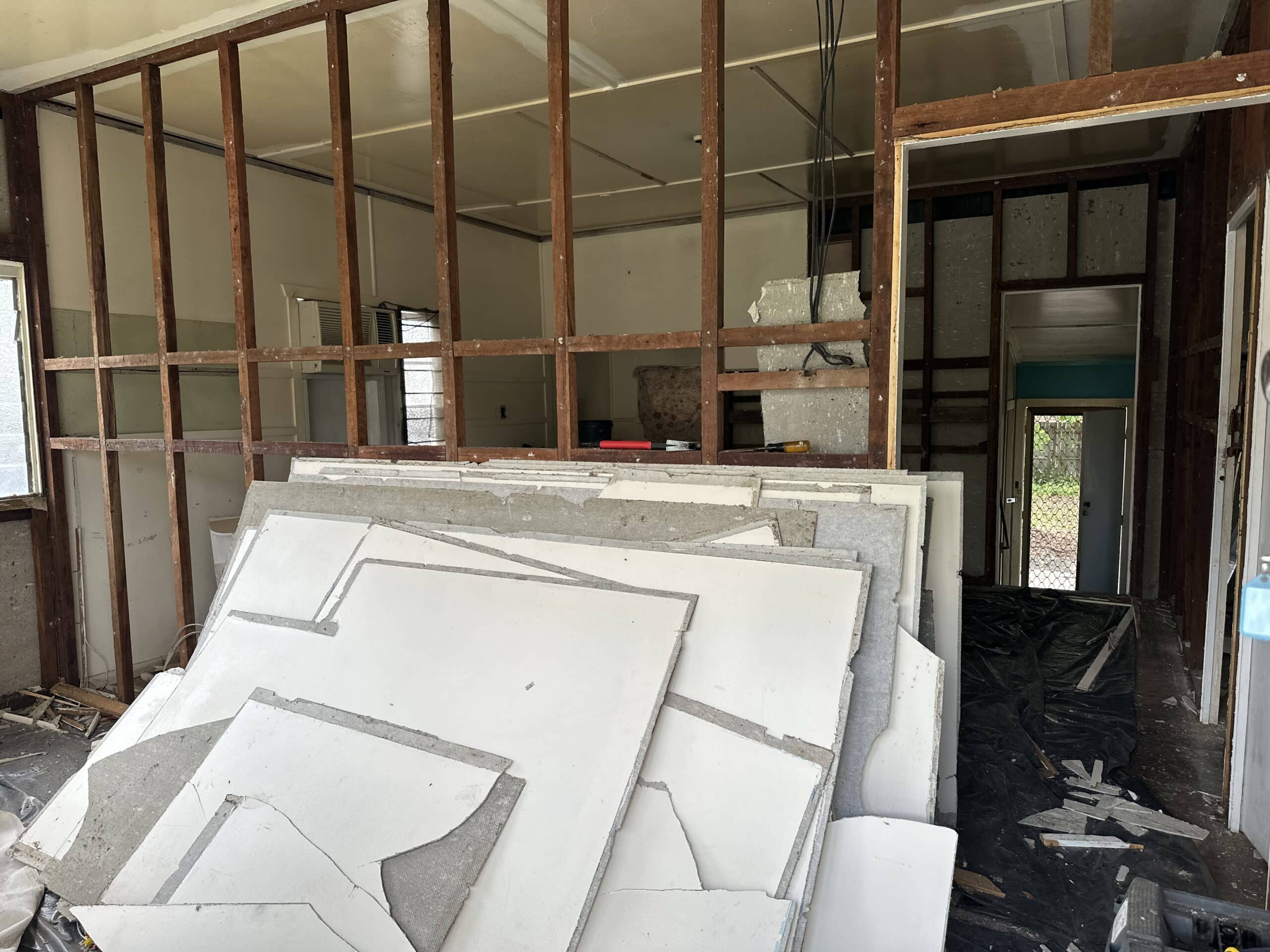 Bonded asbestos cement flat sheeting installed as internal wall lining in an old Queenslander