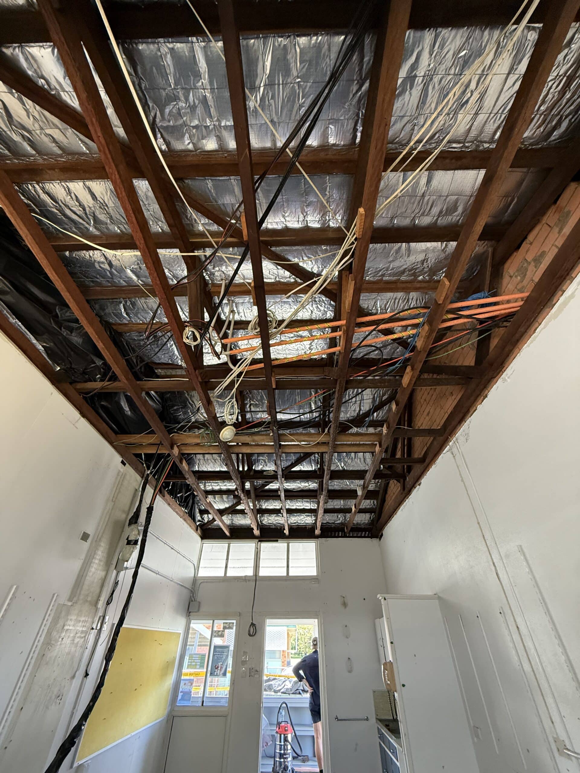 Clean ceiling space after bonded asbestos cement sheeting has been fully removed.