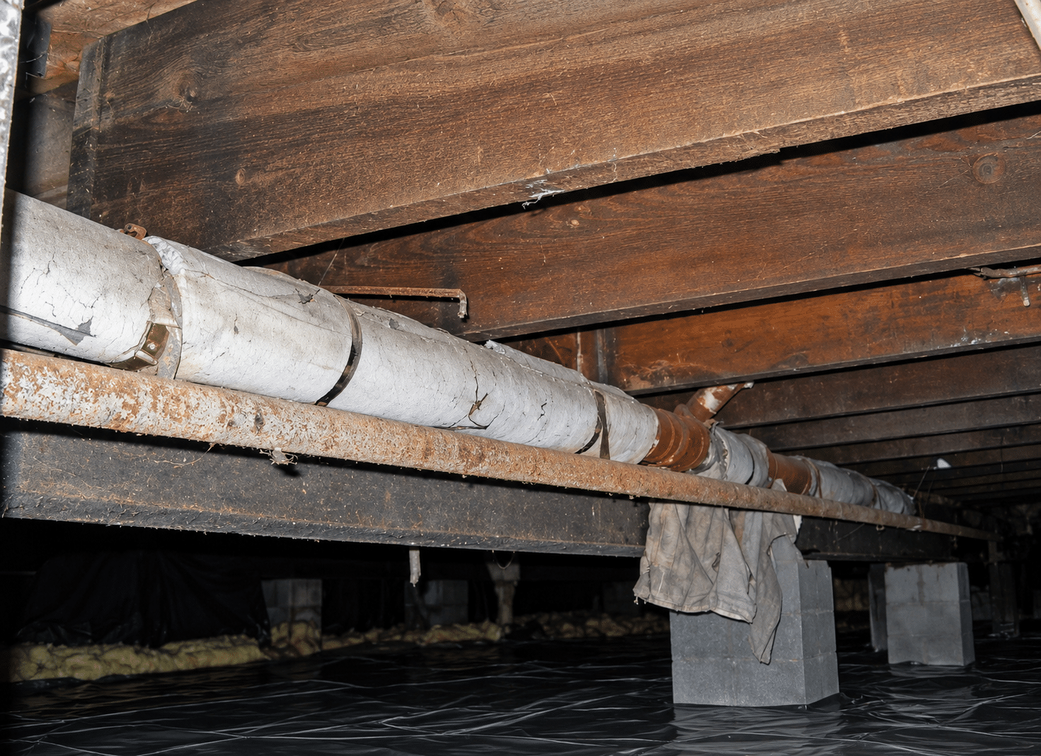 Degraded friable pipe lagging containing asbestos under a house