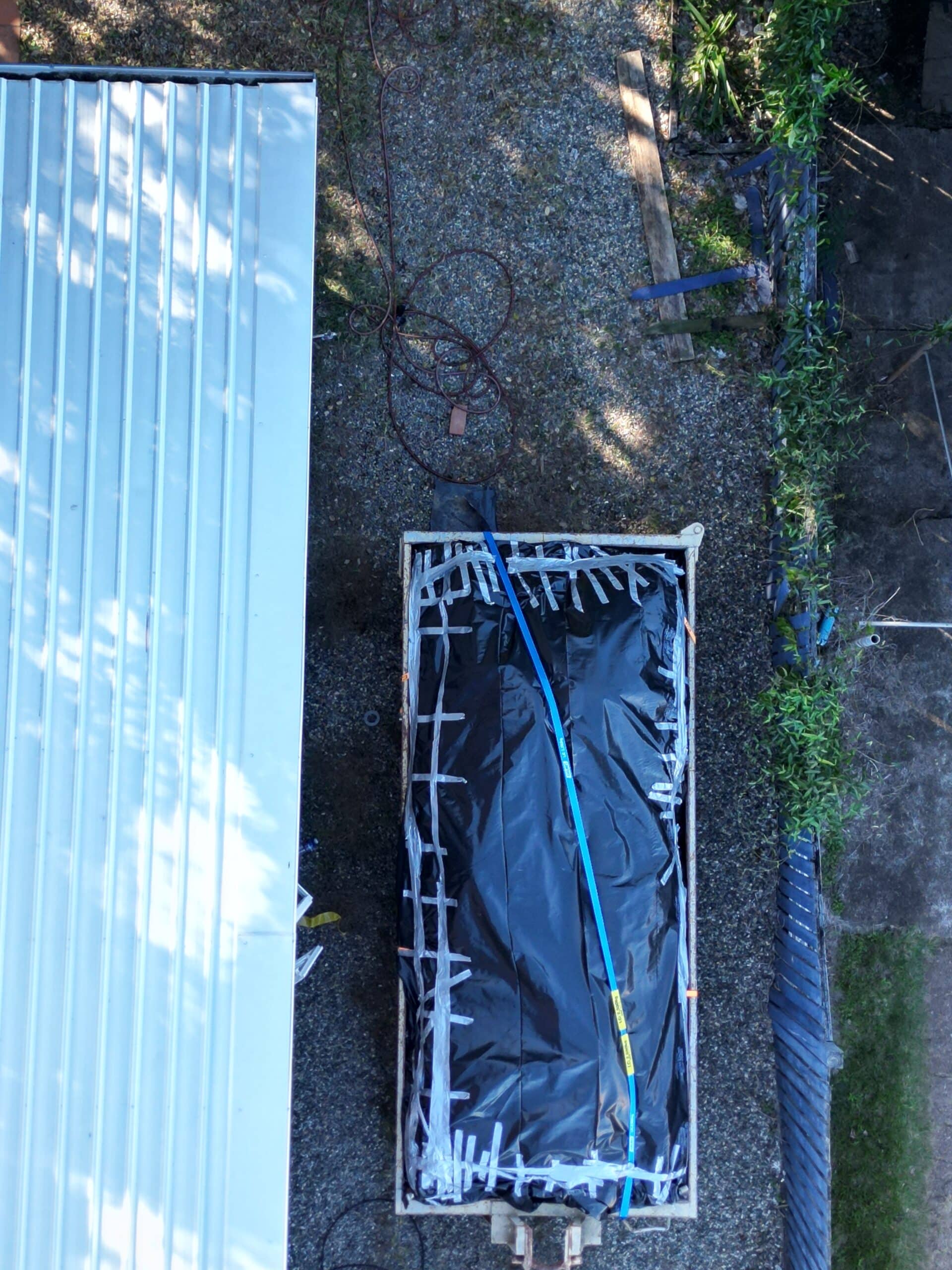 Aerial view of asbestos waste staged for licensed transport and disposal