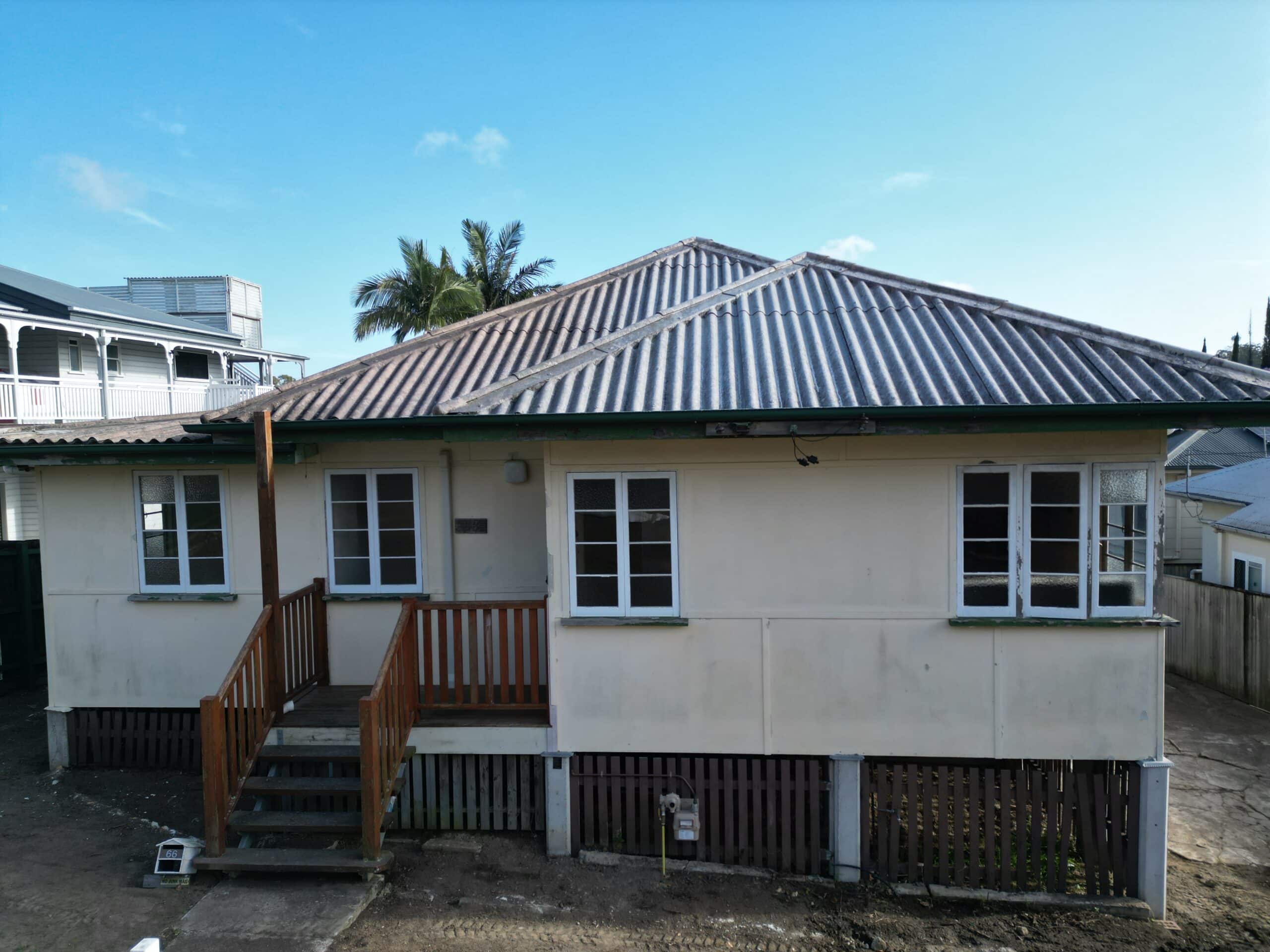 Corrugated asbestos cement roofing and eaves lining on an older building.