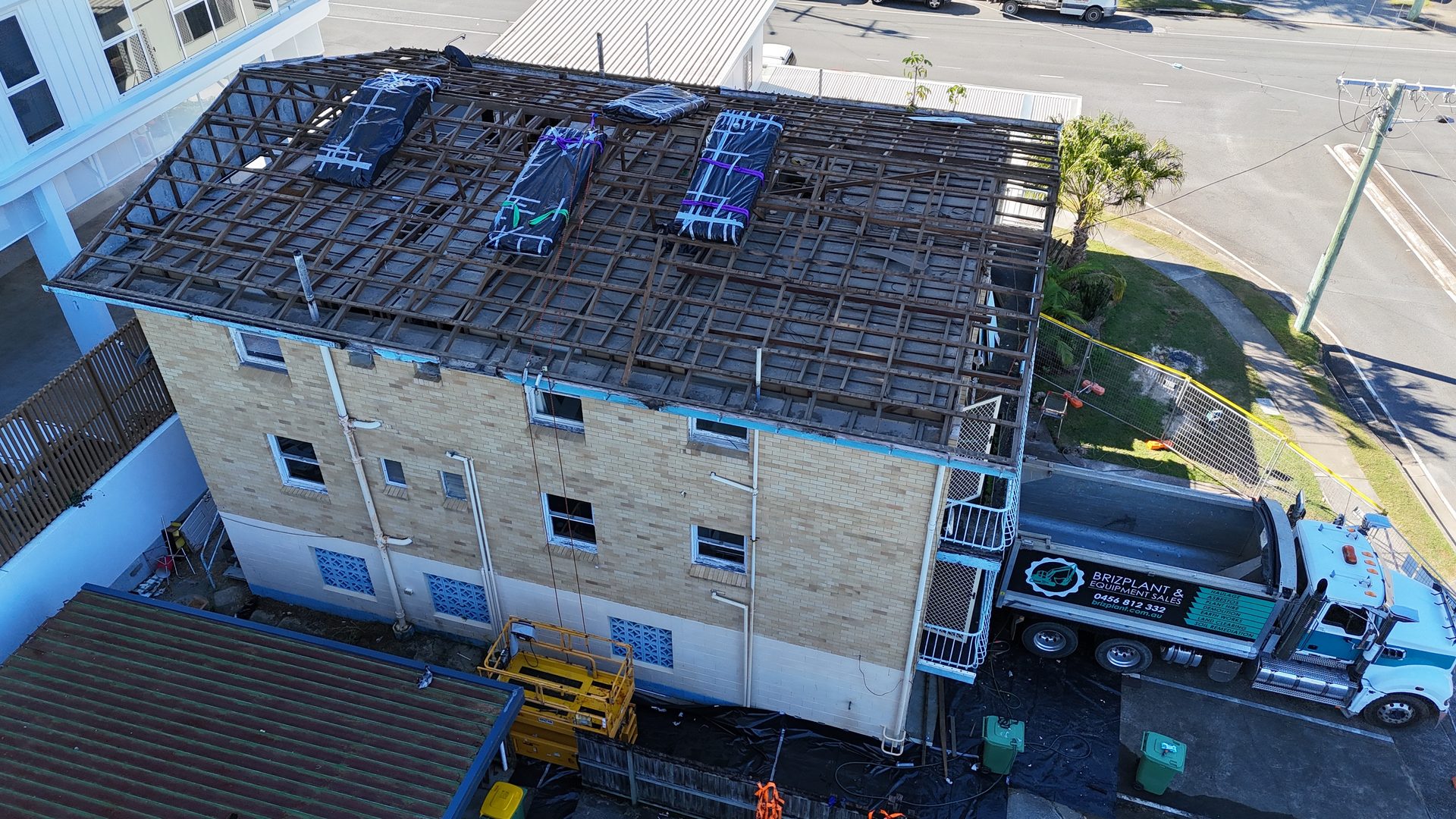 Roof removal by crane, aerial view