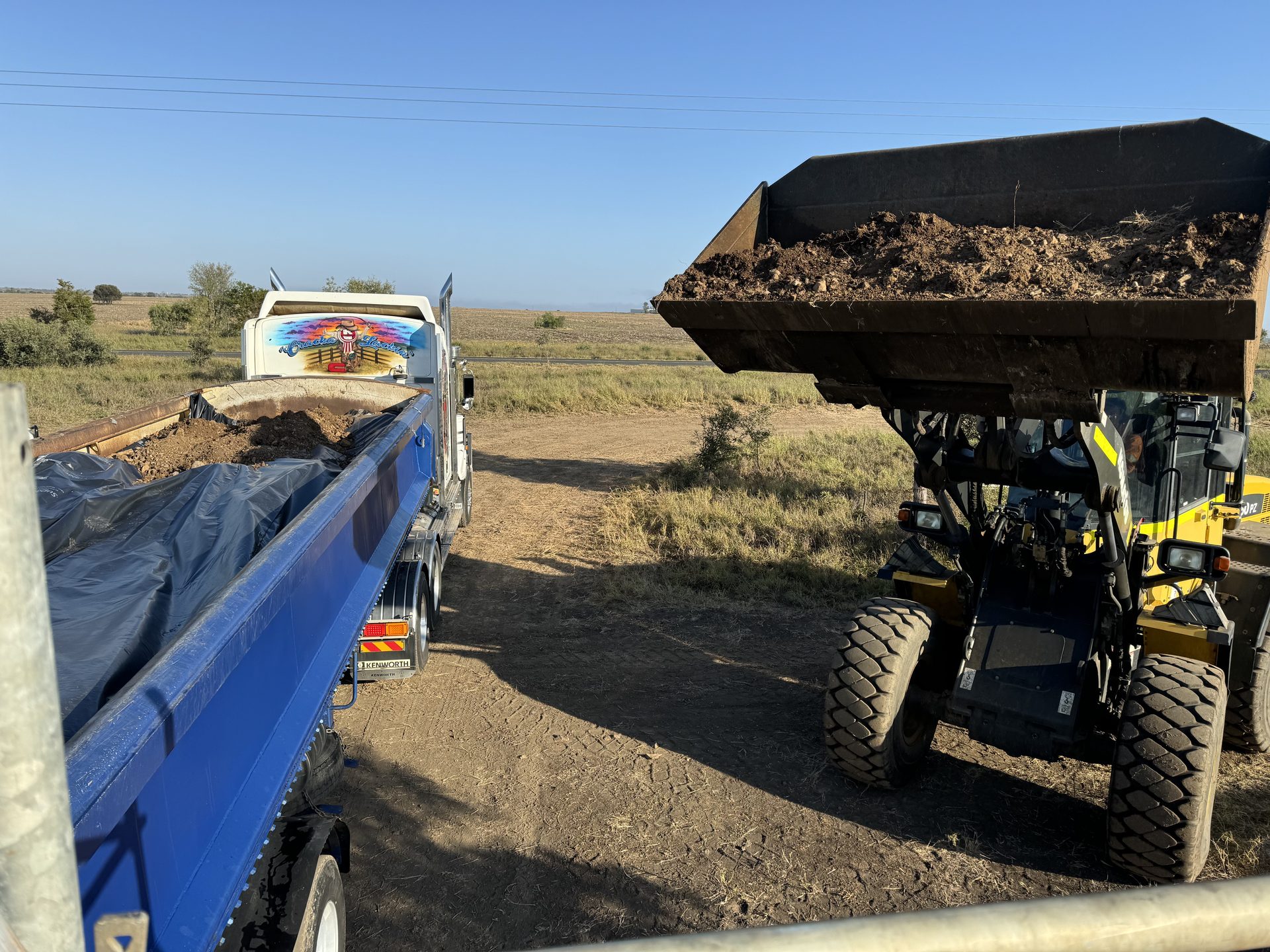 Loader filling lined tipper