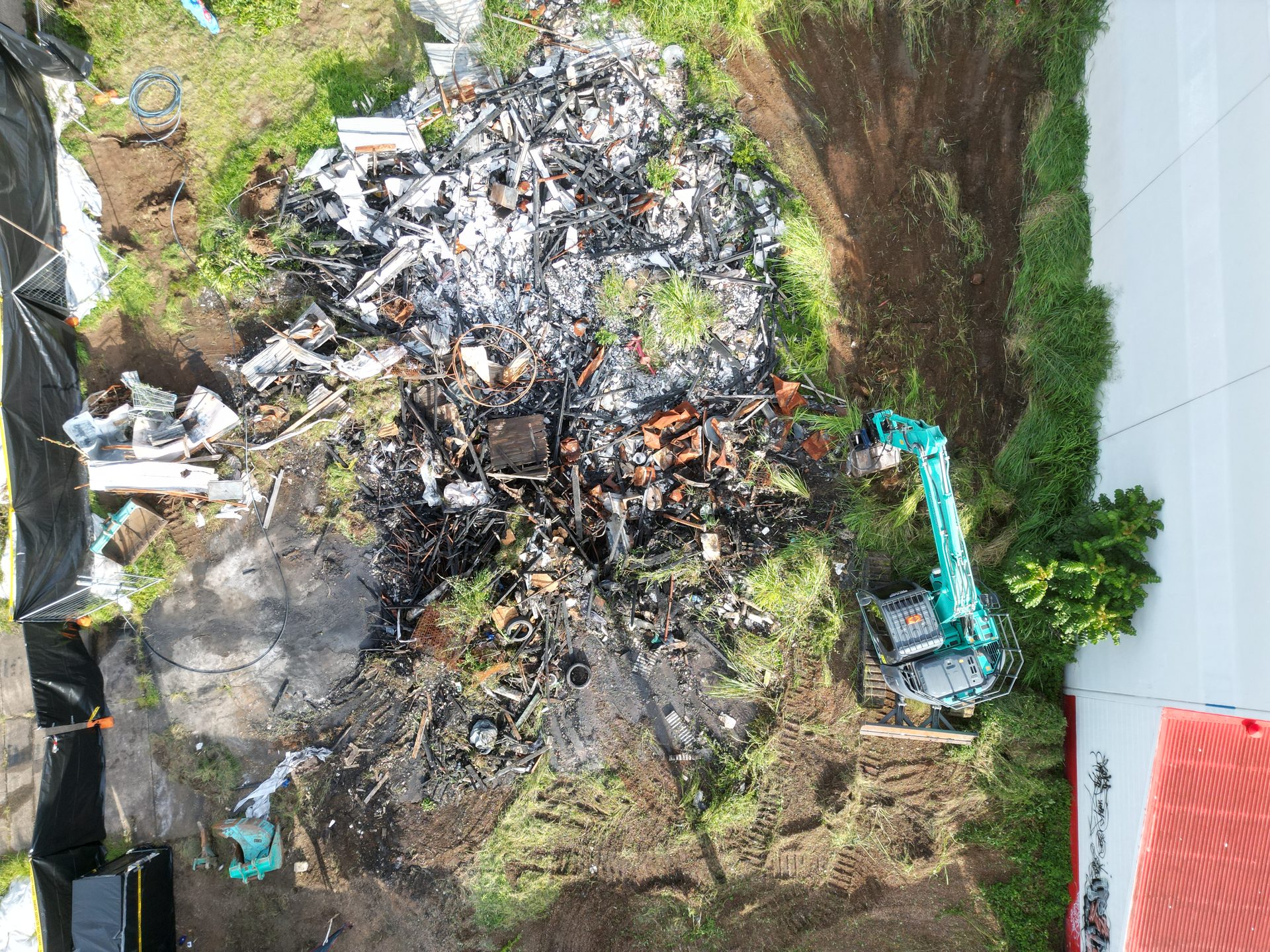 Excavator clearing debris, aerial